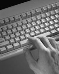 Photo of a hand using a computer keyboard